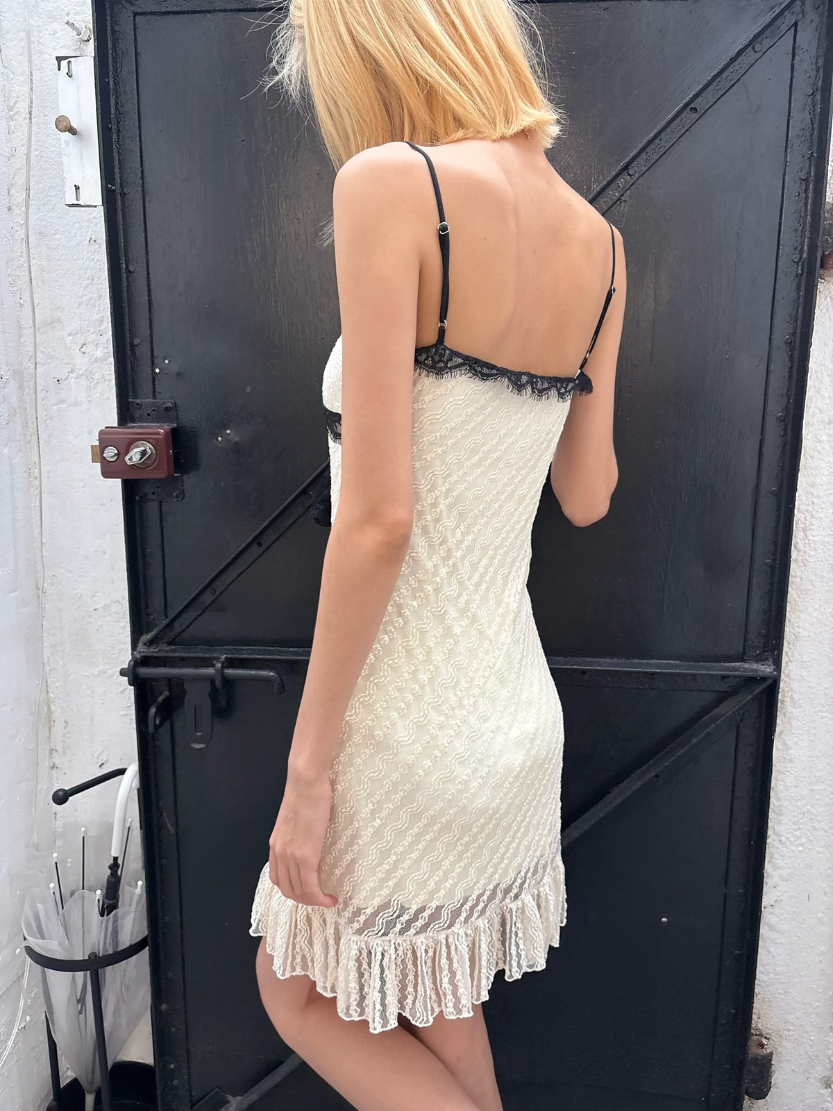 Whitetrimmed halter dress with detachable brooch