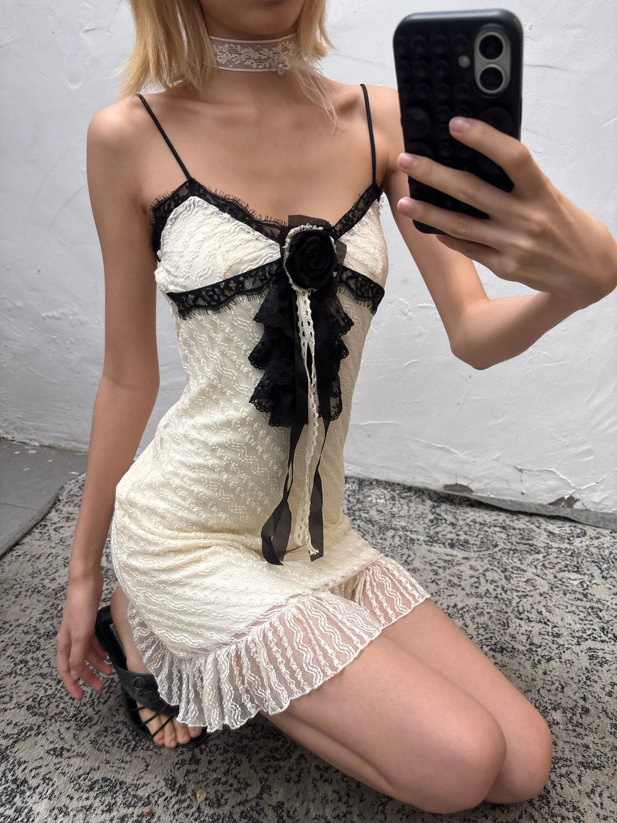 Whitetrimmed halter dress with detachable brooch