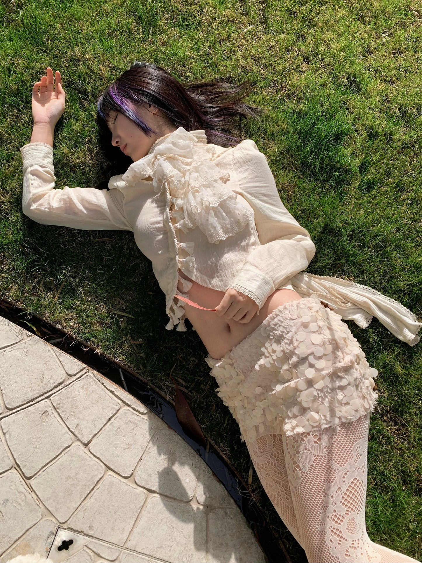 Beige doll shirt with a ruffled collar, lace tassels and an asymmetrical design
