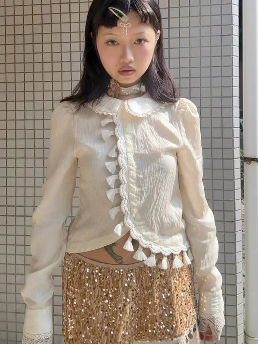 Beige doll shirt with a ruffled collar, lace tassels and an asymmetrical design